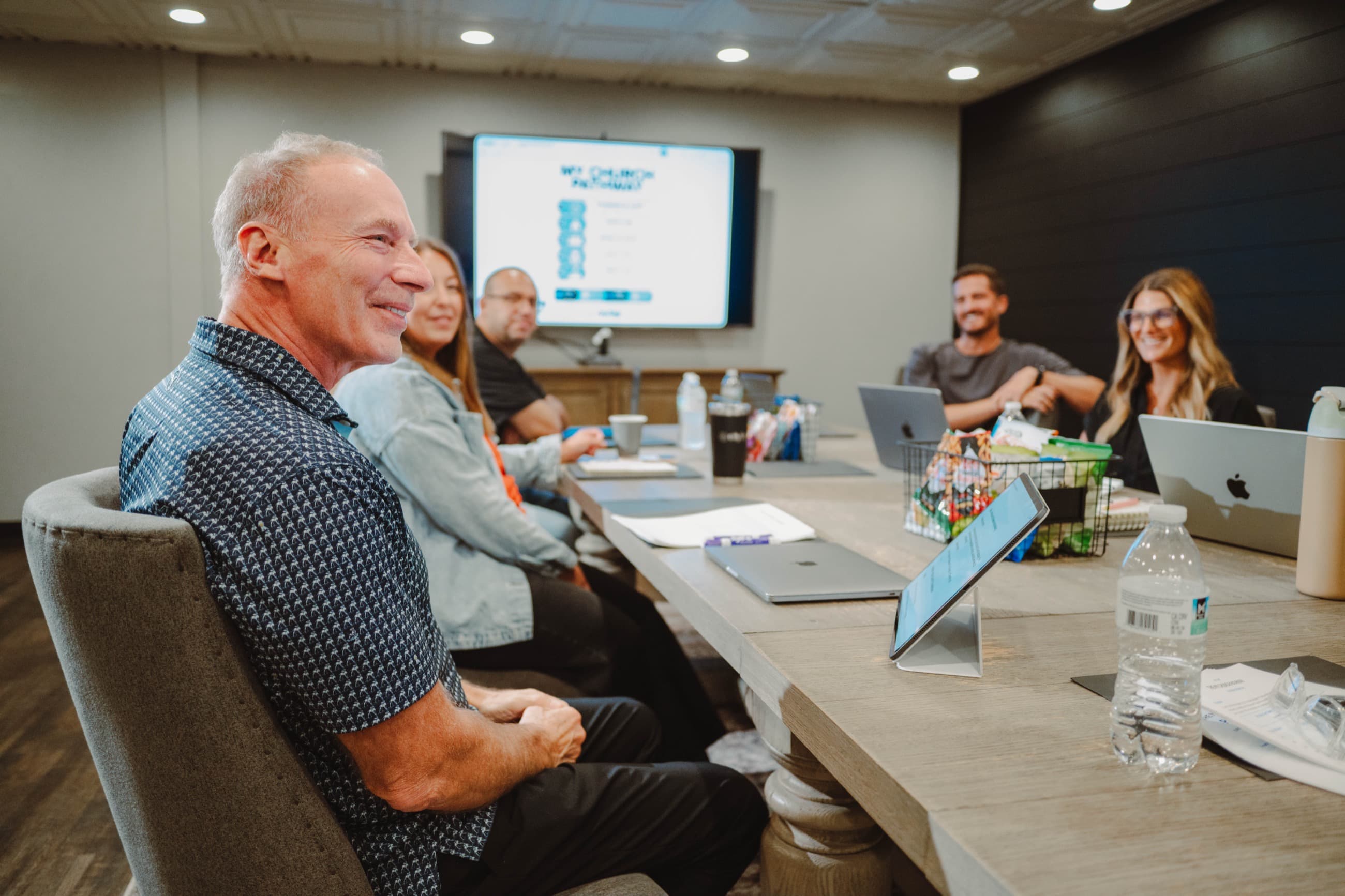 Mike Bodine leading a leadership meeting around a conference table